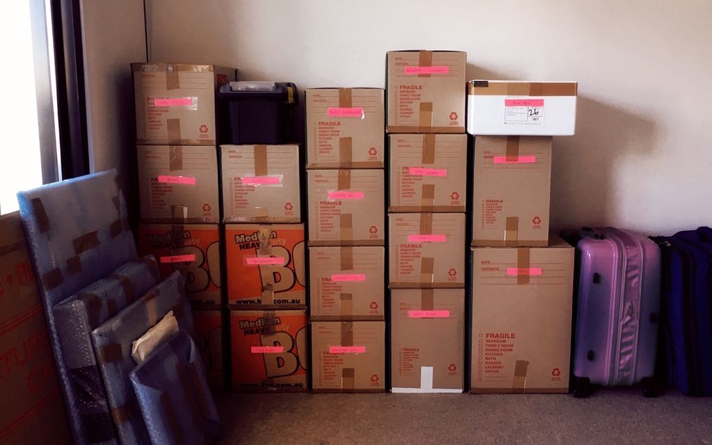 professional moving boxes organized and stacked against a wall