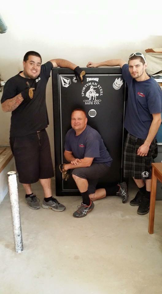 Professional movers next to a gun safe they moved